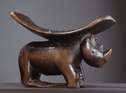 A headrest with support carved as a rhinoceros
