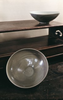 Two large bowls coated with a pale blue glaze and decorated with stylized phoenixes