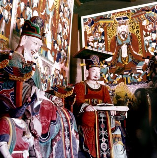 Thankas and statues of Taoist sages or monks inside the temple on Diamond Mountain