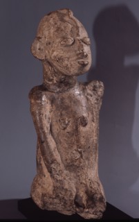 A terracotta figure with a snake curling down the forehead