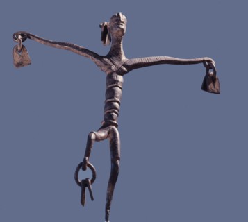 An altar iron in the form of a stylized dancing figure