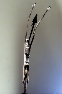 An altar iron in the form of a stylized figure with upraised arms