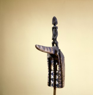 A hornbill mask topped by a female figure, this is one of over seventy different types of mask to dance at the great drama commemorative celebrations of important Dogon elders