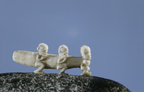 Ivory ear bolt decorated with three small tiki figures