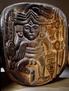 Stone mask of Xipe Totec, the Flayed Lord, dressed in the skin of a sacrificial victim