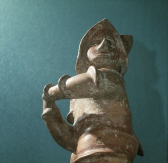 Standing ithyphallic figure, holding phallus