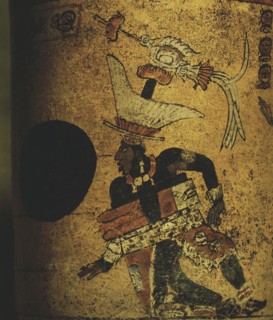 Cylindrical vessel decorated a Mayan ball player wearing black body paint and heavy padding for the competition