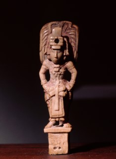 Bone carving of a Mayan dignitary wearing rich garments