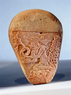 Relief carving depicting the ruler Itzamna sitting on a throne holding a vision serpent