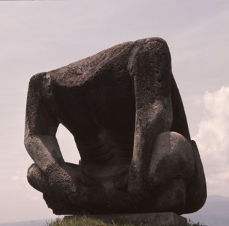 Massive Olmec seated stone figure, with head missing