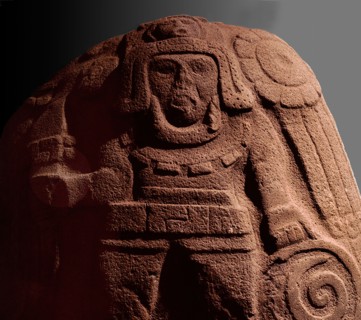 Relief carving representing a warrior with shield and war bonnet
