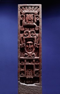 Stone column depicting Quetzalcoatl as Morning Star emerging from the jaws of a serpent   its forked tongue can be seen lolling from its lower jaw