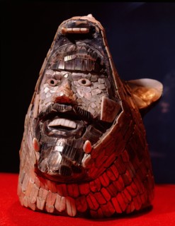 Quetzalcoatl rising from the jaws of the earth as represented by the coyote