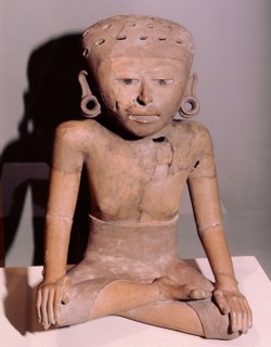 Seated figure of a woman wearing a wrap over skirt and ear spools