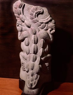 Palmate stone sculpted in the form of a lizard