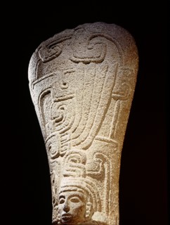 Stone carving ( palmate ) representing a head with elaborate headdress