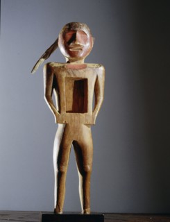 Carved wood figure with rectangular opening in the chest, used by the Midewiwin secret society