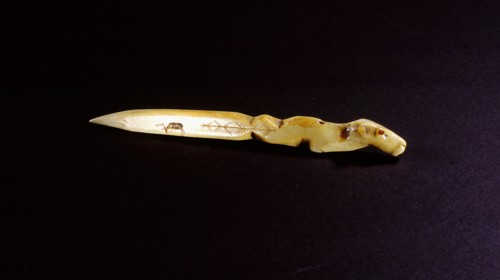 Small ivory knife with the handle carved in the form of an animal head, a caribou incised on the blade