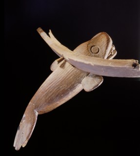 A wood carving of a whale