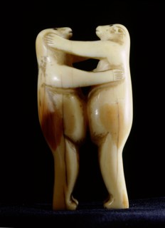 Small carving of two polar bears wrestling