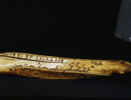 Incised bow drill handle illust rating a number of scenes