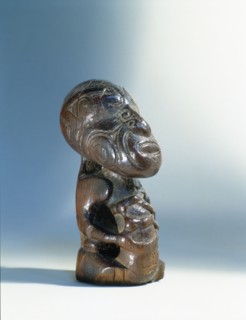 Small seated Maori figure, probably the footrest from a ceremonial digging stick