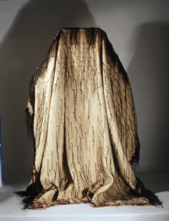 Mans cloak known as korowai, made by finger weaving of fine flax fibres and decorated with black dyed lengths of rolled fibres