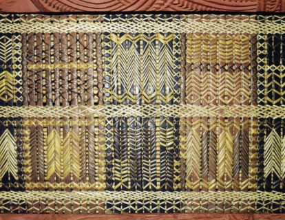 Reed latticework panels woven by women alternated with the carved wooden ancestor figures along the side wall of meeting houses