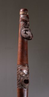 Putorino, or flute trumpet carved with three aggressive faces