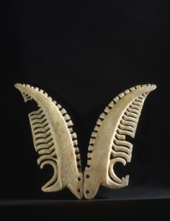 A pair of chevron pendants made from whale ivory