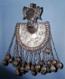 A brass pectoral ornament, part of a chiefs regalia, depicting a rams head