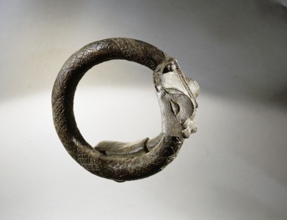 A Benin armlet terminating in a crocodile head