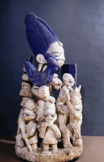 A shrine figure displaying the attributes of wealth (the horse), fertility (the nubile woman and her child), and power expressed by numerous followers