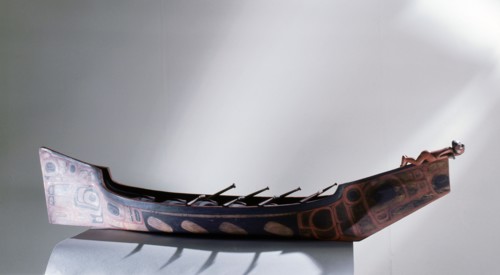 Painted war canoe with figurehead