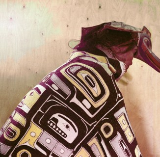 Model of a dancer wearing a cloak and a ceremonial headdress