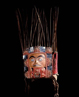 Frontlet with a human figure surrounded by seven smaller figures interspersed with abalone shell