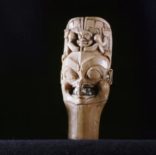 Probably a shamans charm showing the common Northwest Coast feature of applying symbols of animals to essentially human faces