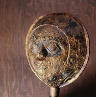 Shamans rattle in the form of a face with a border carved in low relief