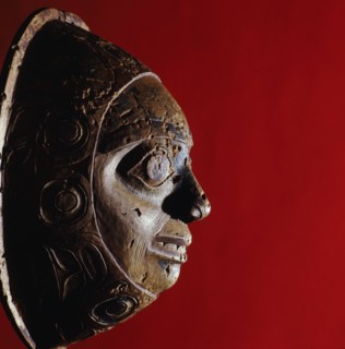 Shamans rattle in the form of a face with a border carved in low relief