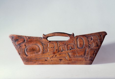 Bark shredder made of wood and carved in relief