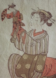 The courtesan Hatsuito playing with a doll
