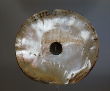 A warriors chest ornament made from a haliotis shell