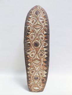 Shield with stylised low relief design