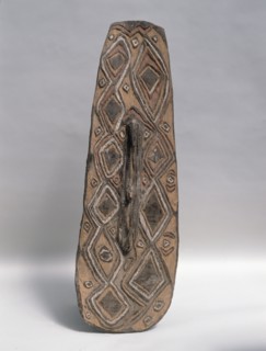 Shield with stylised low relief design