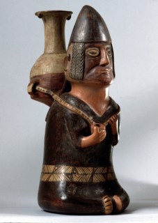 An effigy ceramic showing a male figure carrying the Inca aryballus on his back