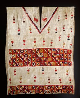 This Inca poncho, with interlocking designs, depicts plants and felines