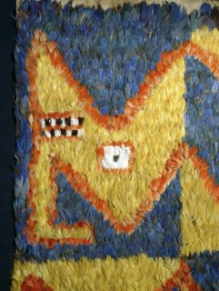Featherwork tabbard with dragon head motif