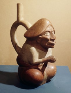 Stirrup spouted vessel depicting seated figure with phallic headdress