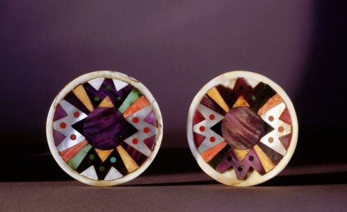 Two discs of turquoise and shell (and possibly jet and lapis), with an abstract geometric design, used either as earrings or worn on clothing
