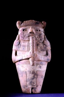 Hollow ceramic effigy flute player wearing jaguar headdress
